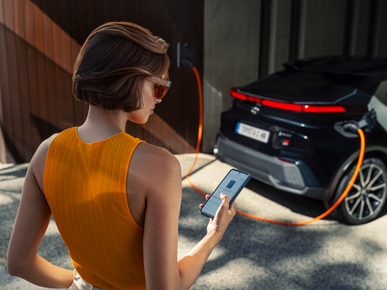 woman standing next to Toyota HomeCharge