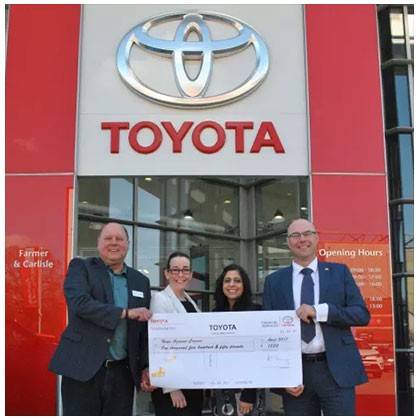 Farmer and Carlisle Toyota Leicester presenting a cheque