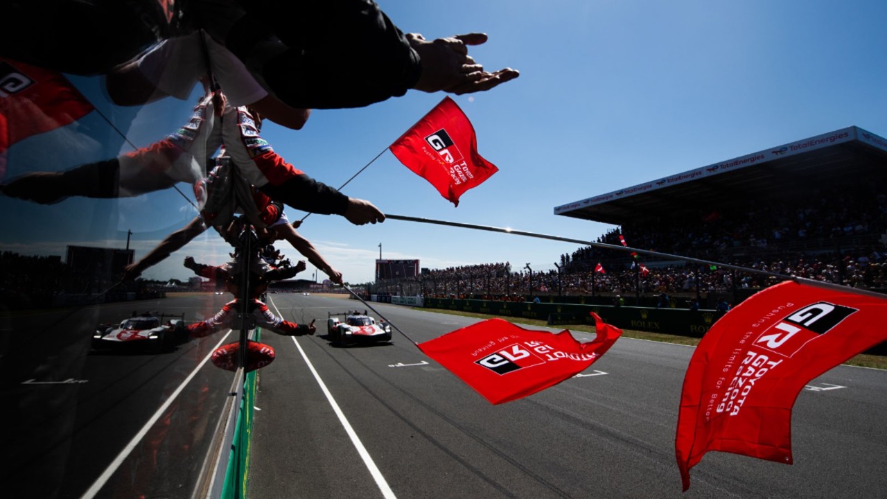 Toyota Motorsport fans waving red Gazoo Racing flacks at track