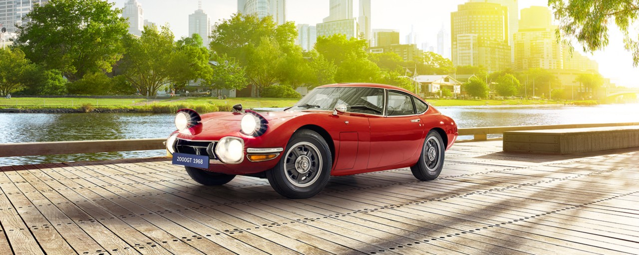 Toyota 2000GT car in red next to other cars