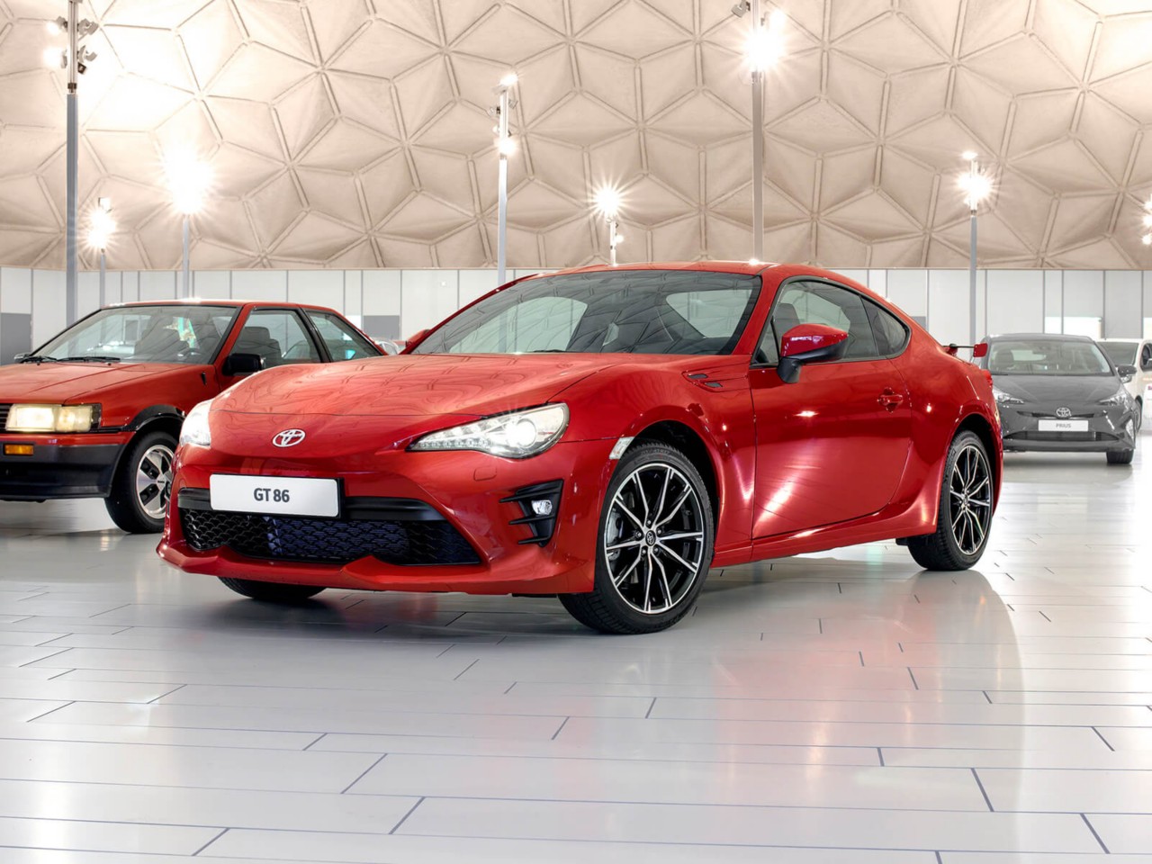 Toyota GT86 in red side front angle next to other cars
