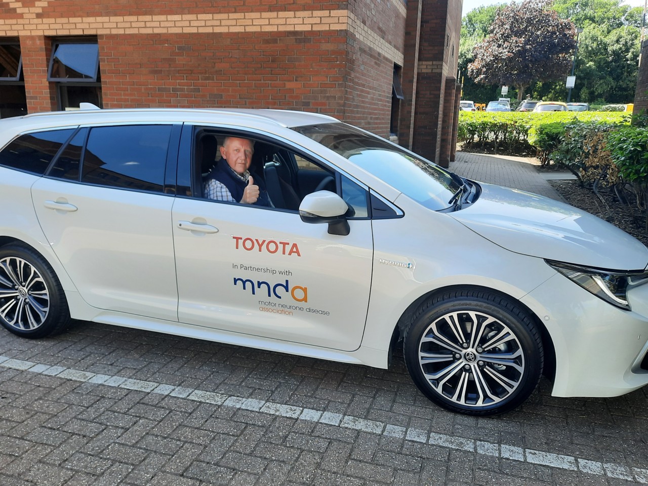Toyota MNDA charity with elderly man driving car