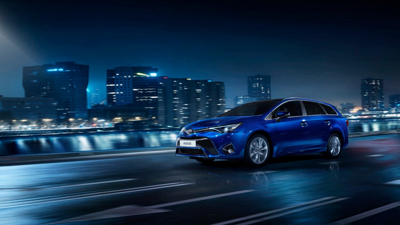 Blue Toyota Avensis driving at night