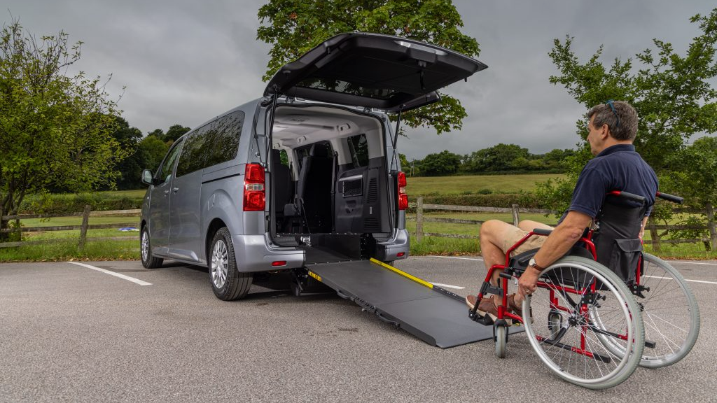 Toyota GM Coachwork Van Picking Up A Man In A Wheelchair