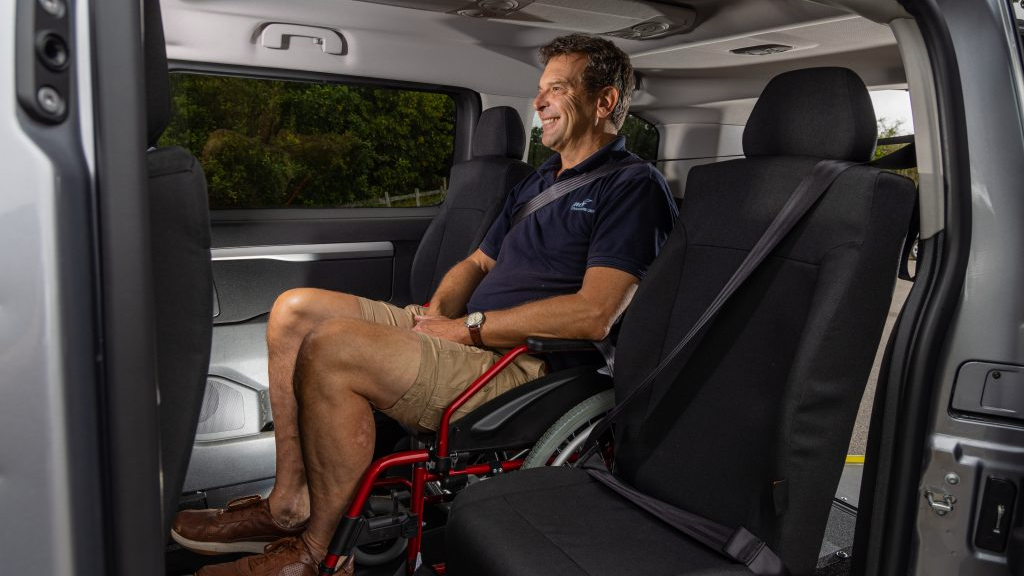 Toyota GM Coachwork Man in a wheelchair sitting inside a van