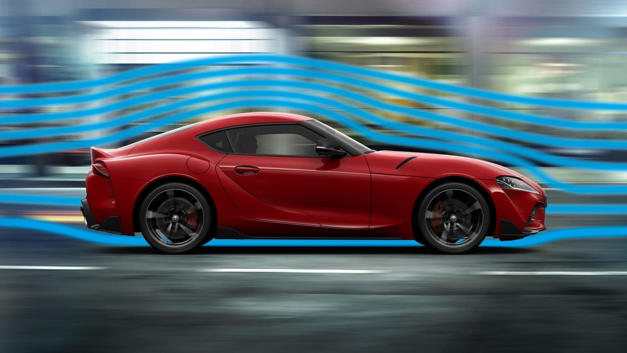 Toyota Supra driving along a road with slip stream graphic